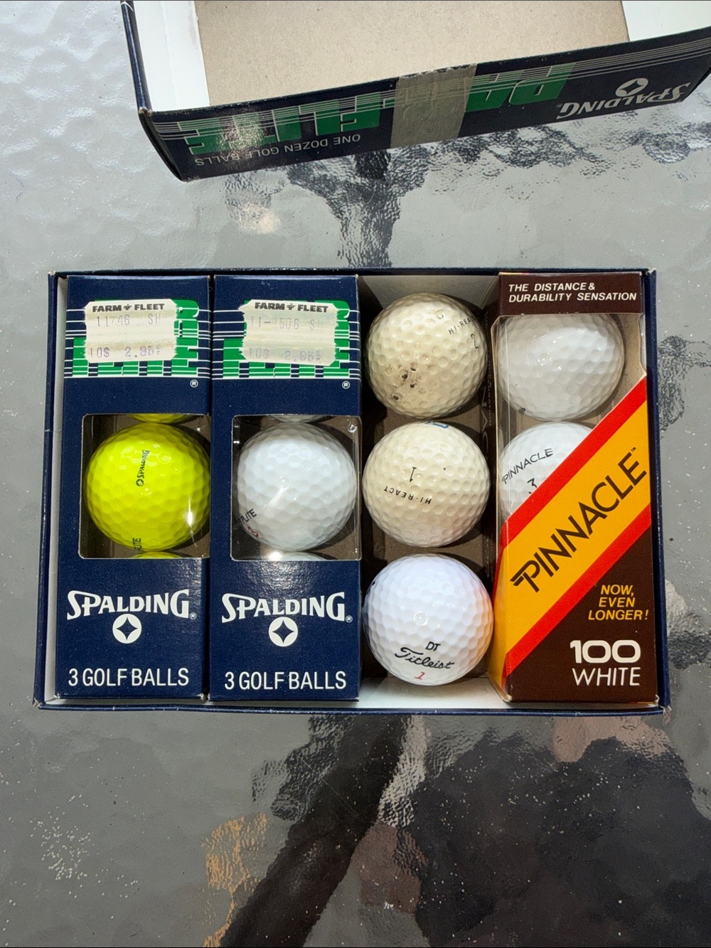 box of assorted vintage golf balls